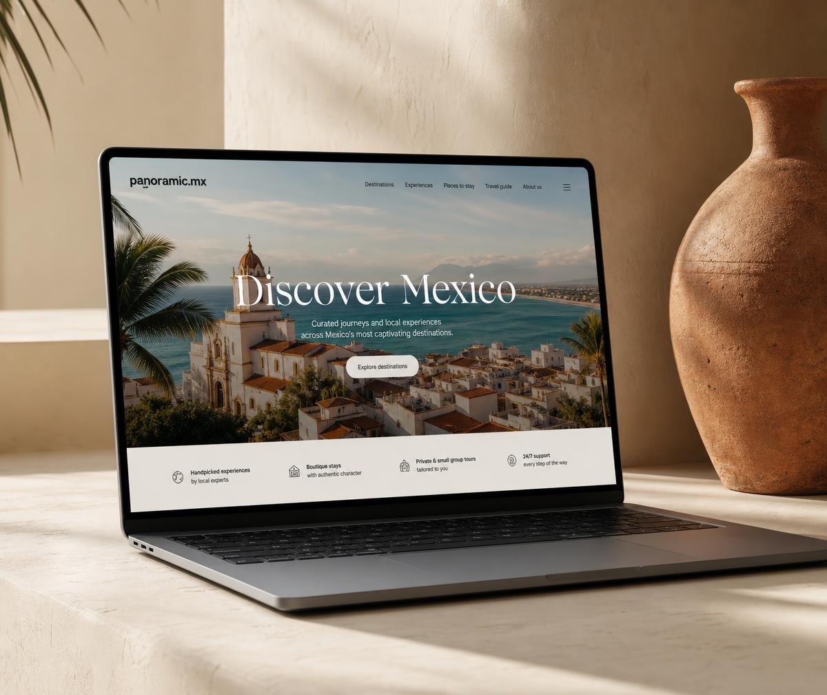 A laptop showing the panoramic.mx travel website on a warm neutral desk